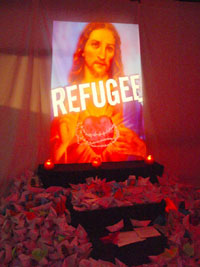 Photo of shrine Origami boats surround the refugee Jesus ref