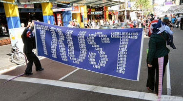 Liberal party rats holidng the TRUST the Lies Banner a the End teh Lies Rally